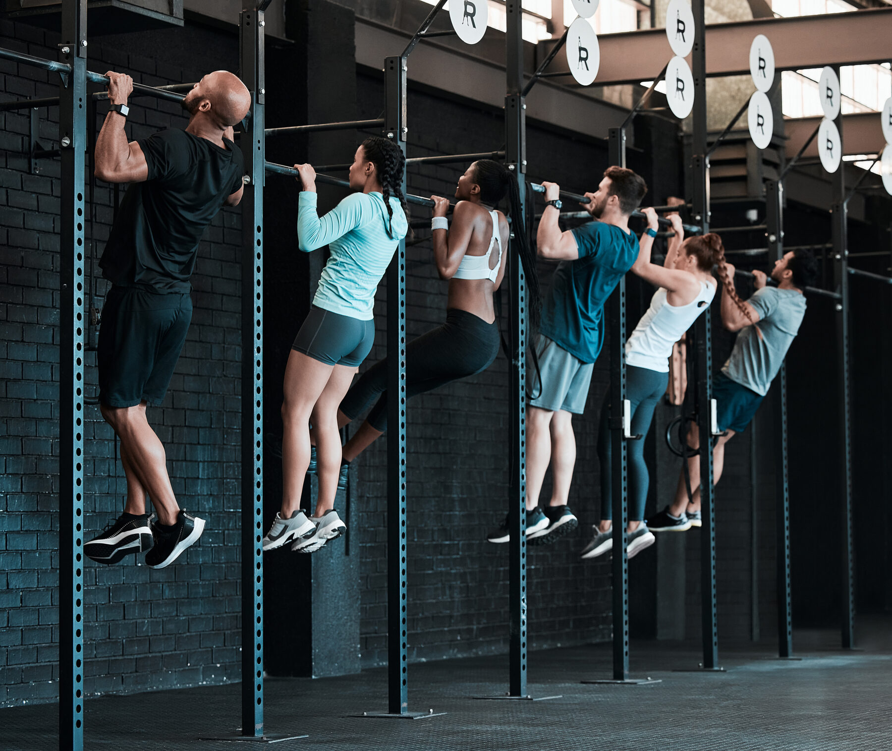 shot-of-a-group-of-people-completing-pull-ups-together